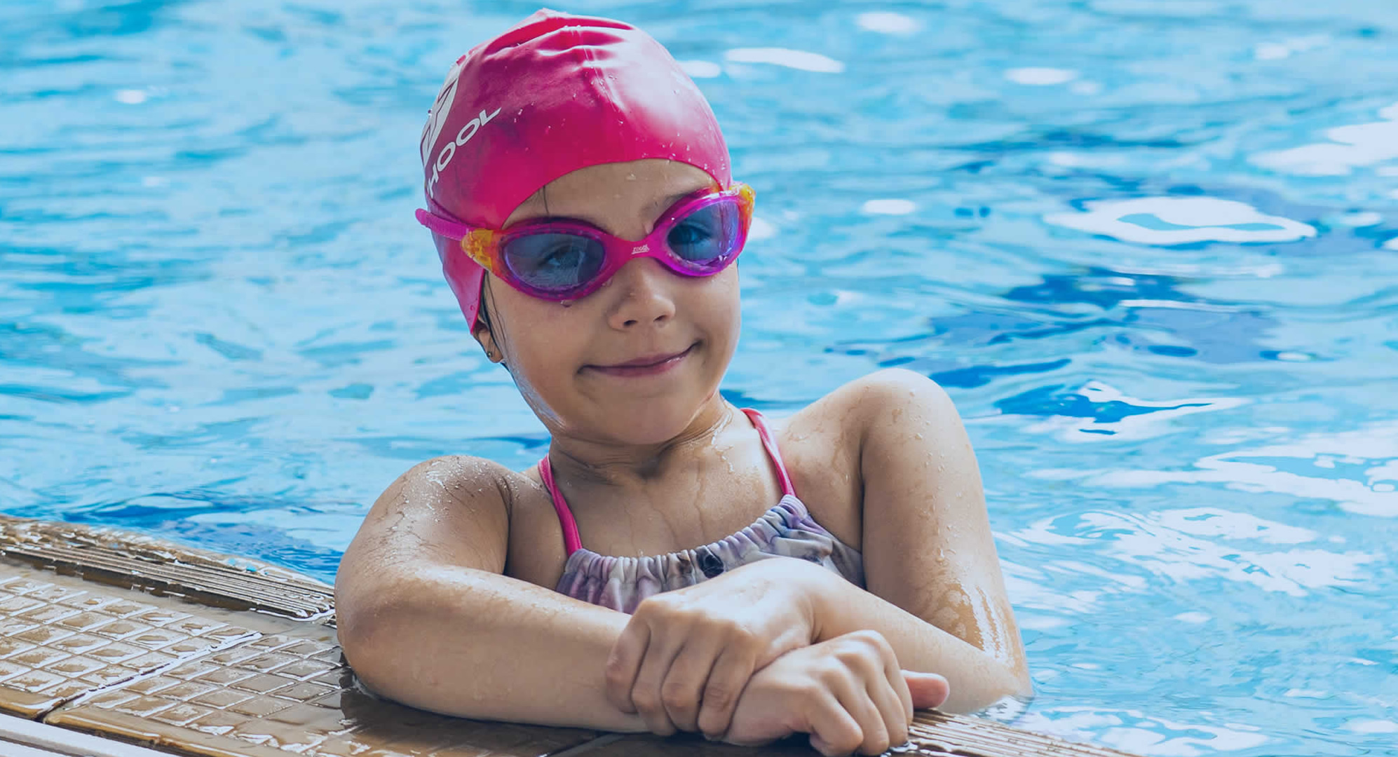 An image of an S4 swimmer at the side of a swimming pool.